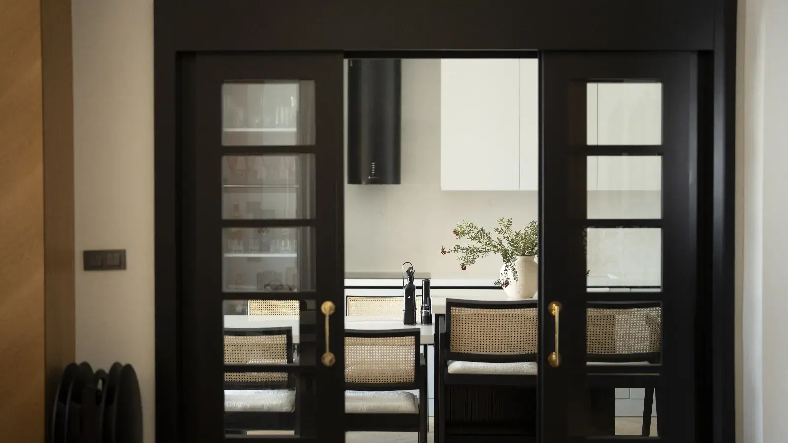 Black-framed glass doors and dining area — Izmir Villa II, Izmir